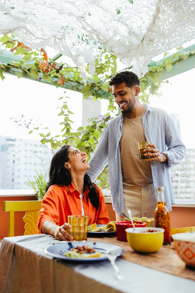 Happy Latin American couple enjoying lunch together on a beautiful garden terrace