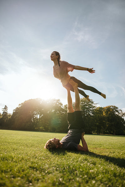 Fit young couple doing acrobatic yoga