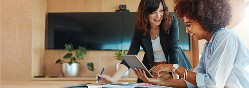 Creative female executives using digital tablet in office