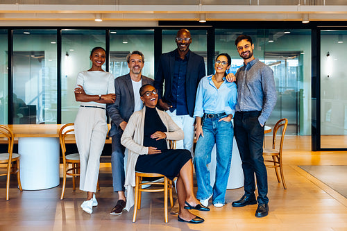 Group of professionals posing together in creative office
