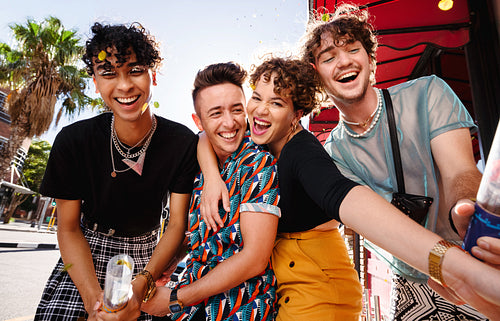 Carefree friends celebrating with confetti outdoors