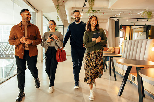 Multiethnic businesspeople walking through a modern office