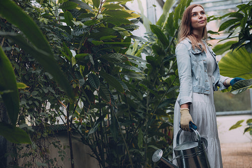 Young woman working in greenhouse