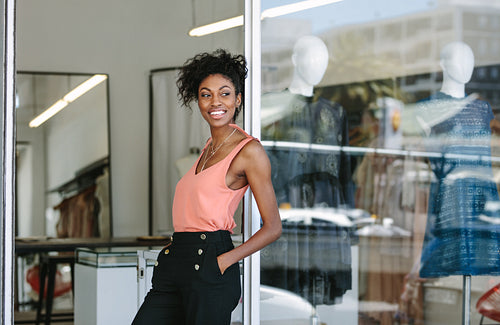 Female fashion designer standing in her boutique.