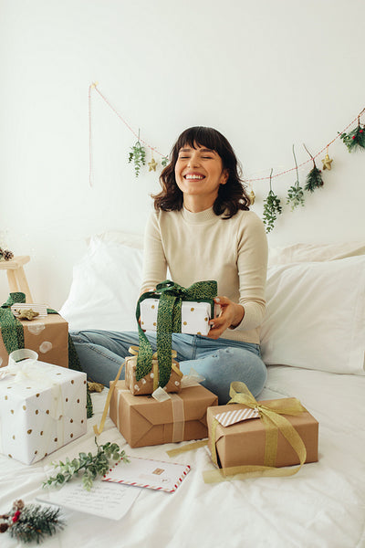 Cheerful woman sitting with her christmas presents