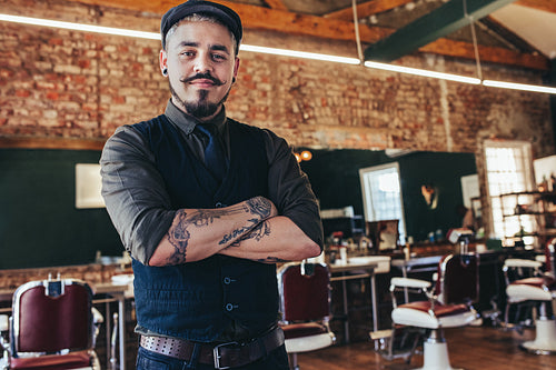 Handsome young man standing at barber shop