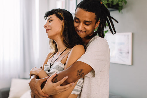 Loving young couple bonding indoors