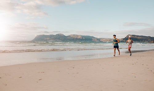 Couple on morning run at the beach