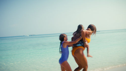 Happy family enjoying a luxury tropical beach vacation at a beautiful resort