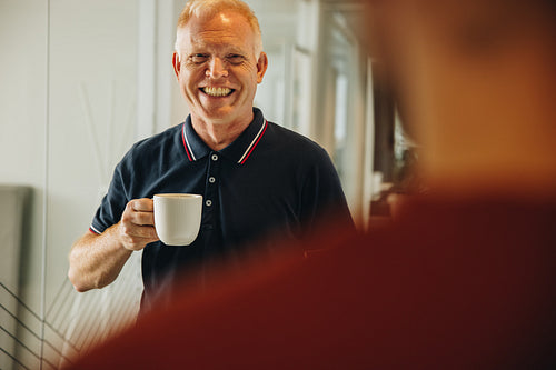 Senior businessman having coffee break
