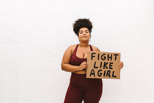 Healthy woman with "Fight like a girl" sign