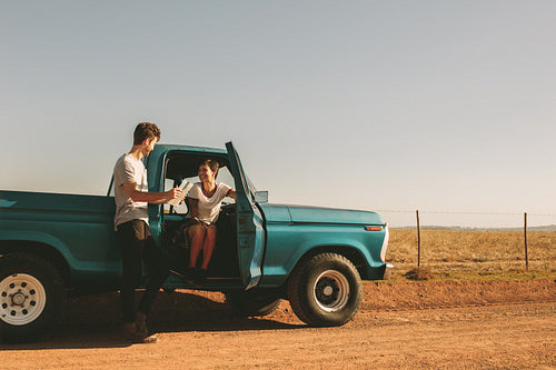 Couple on a road trip looking at map for navigation