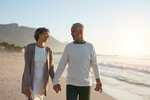 Loving senior couple strolling together on the beach