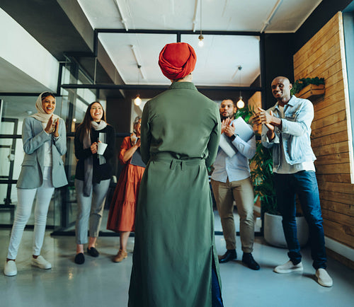 Successful businesswoman receiving an applause in an office