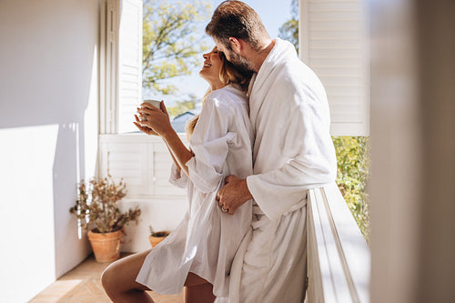 Tourist couple flirting on a balcony