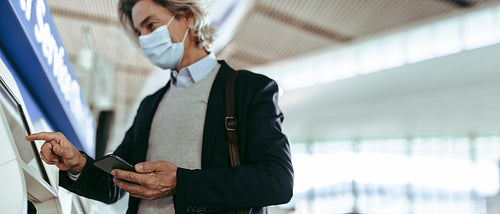 Businessman doing self check-in for flight at airport