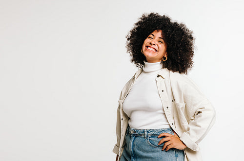 Carefree woman with Afro hair smiling at the camera happily