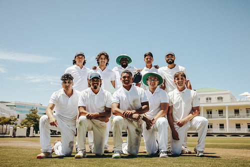 Cricket team posing together for a group photograph outdoors