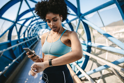 Runner setting up her smart watch for run
