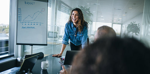 Female professional smiling during a business presentation
