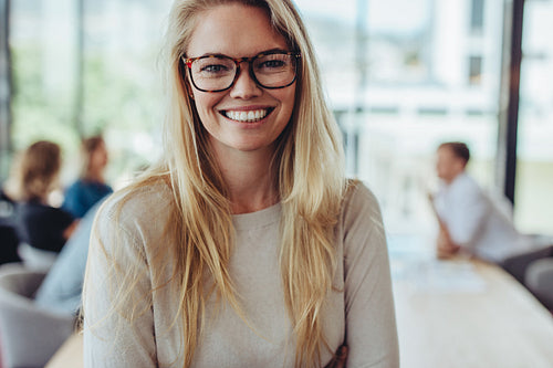 Portrait of happy businesswoman in boardroom