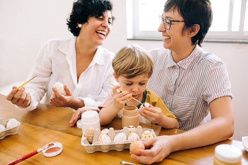 Family having fun while decorating Easter eggs