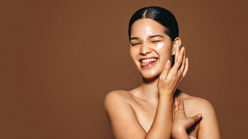 Having fun taking care of my face using cosmetic beauty cream