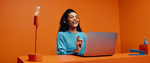 Happy woman using laptop for brainstorming and customer service in e-commerce office