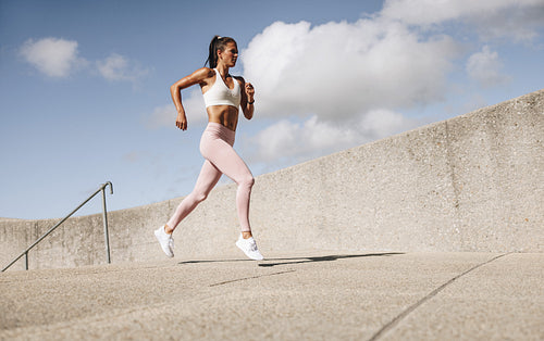 Female athlete running in the morning