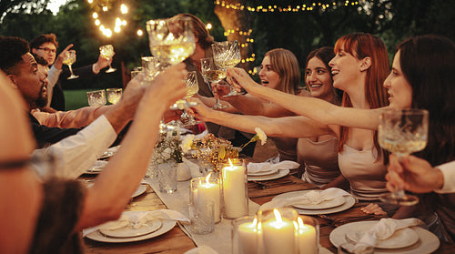 Joyful celebration during an intimate outdoor evening wedding reception