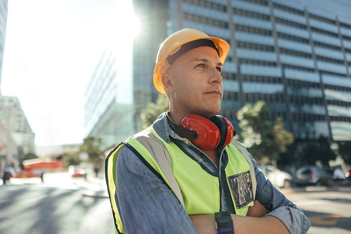 Construction worker looking away thoughtfully