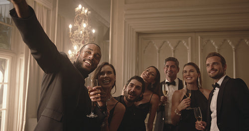 Multi-ethnic friends posing for a selfie at party