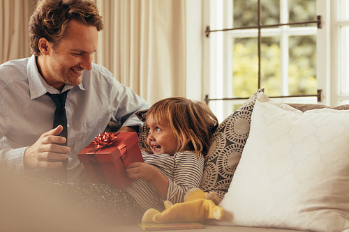Father and daughter sitting at home
