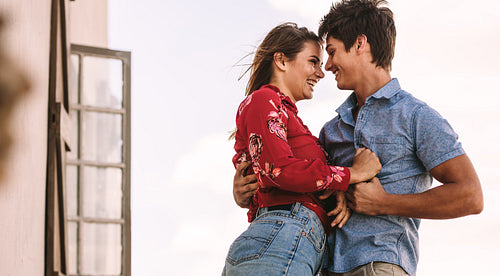 Happy couple standing together outdoors
