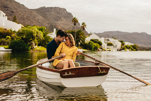 Couple having fun sitting in a boat on a date