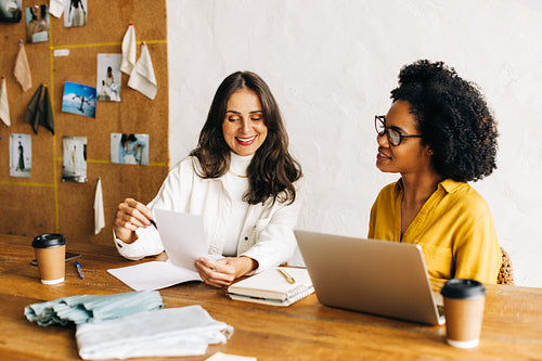 Young female designers: Creative business discussions in a clothing design startup