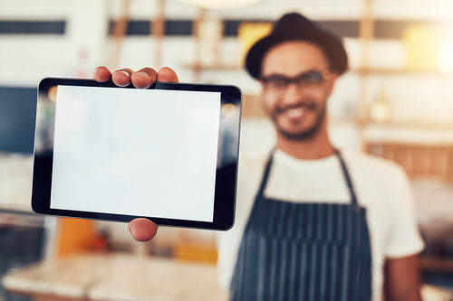 Digital tablet in hand of cafe owner