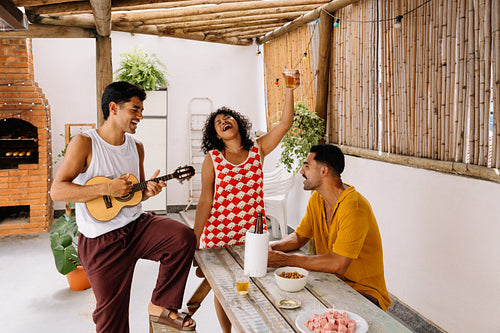Group of friends enjoying pagode music and petiscos outdoors