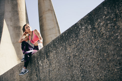 Female athlete taking a break after exercising