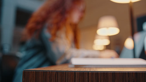 Girl using a laptop to study and prepare for an examination in a campus library