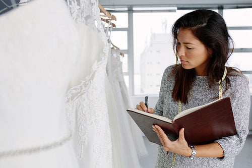 Female dressmaker working in bridal wear store