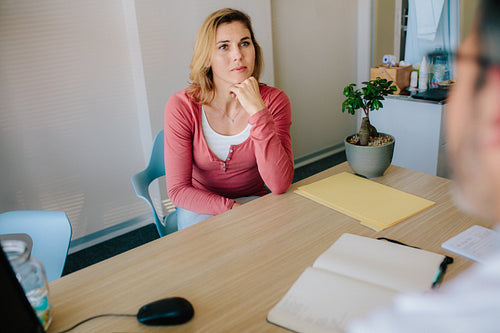 Female patient listening to doctor with concentration