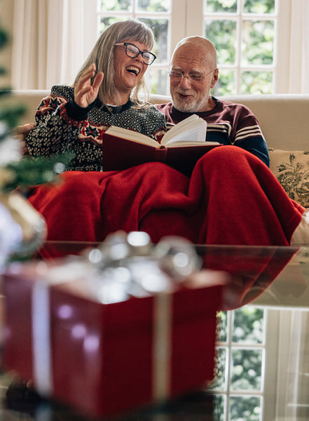 Senior couple spending time together reading a book