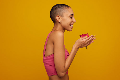 Androgynous woman with rose in hand