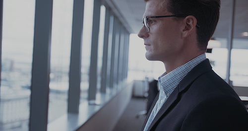 Mature businessman looking outside the window