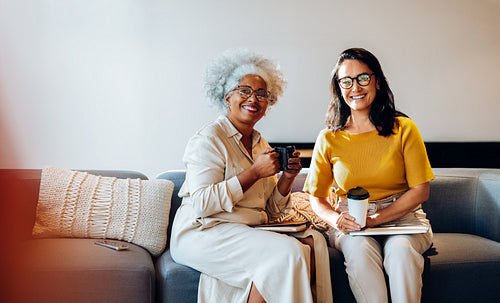 Meaningful exchange: Senior woman and colleague share ideas over coffee
