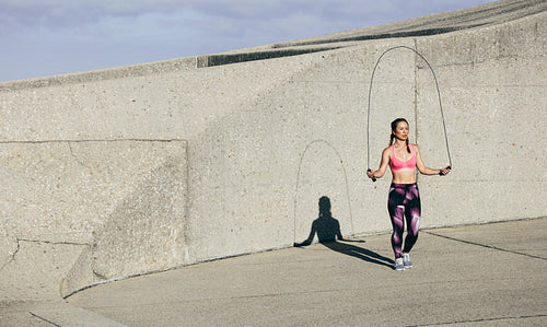 Fit young woman skipping rope