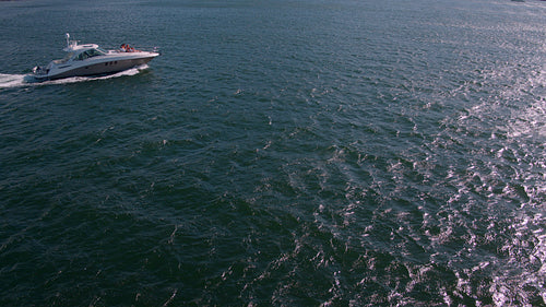 Drone shot of friends relaxing on yacht