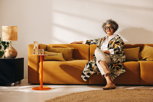 Experienced businesswoman sitting on a couch in an office lobby