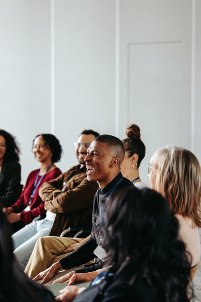 Businessman laughing during a seminar with diverse group of people